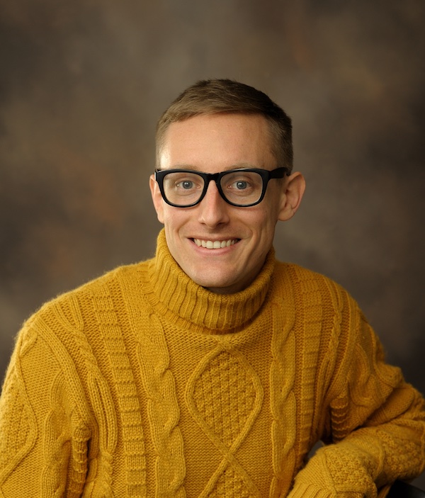 Picture of Nigel wearing a comfy yellow sweater